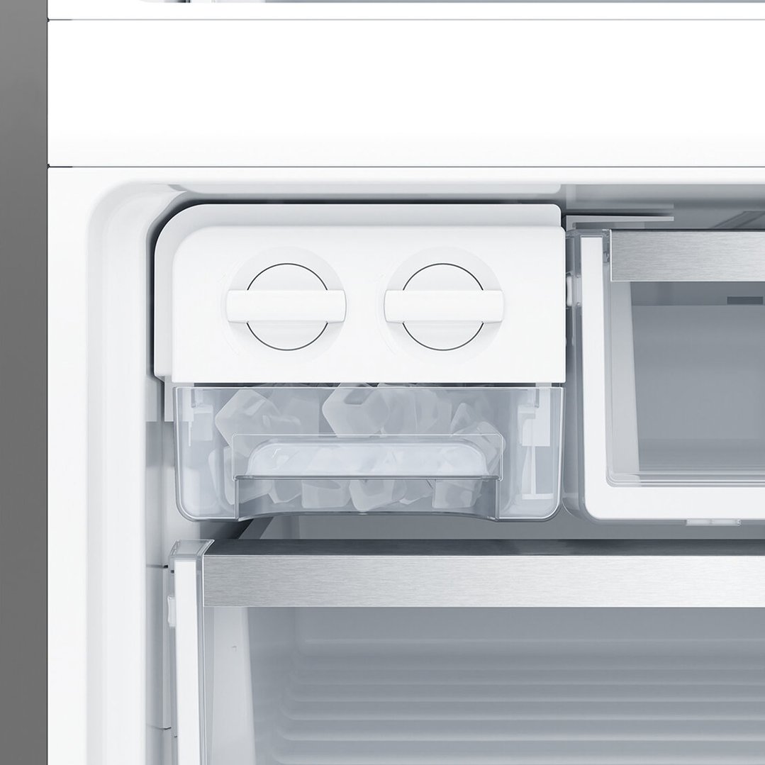 Close up of the ice maker and ice bucket inside a fridge