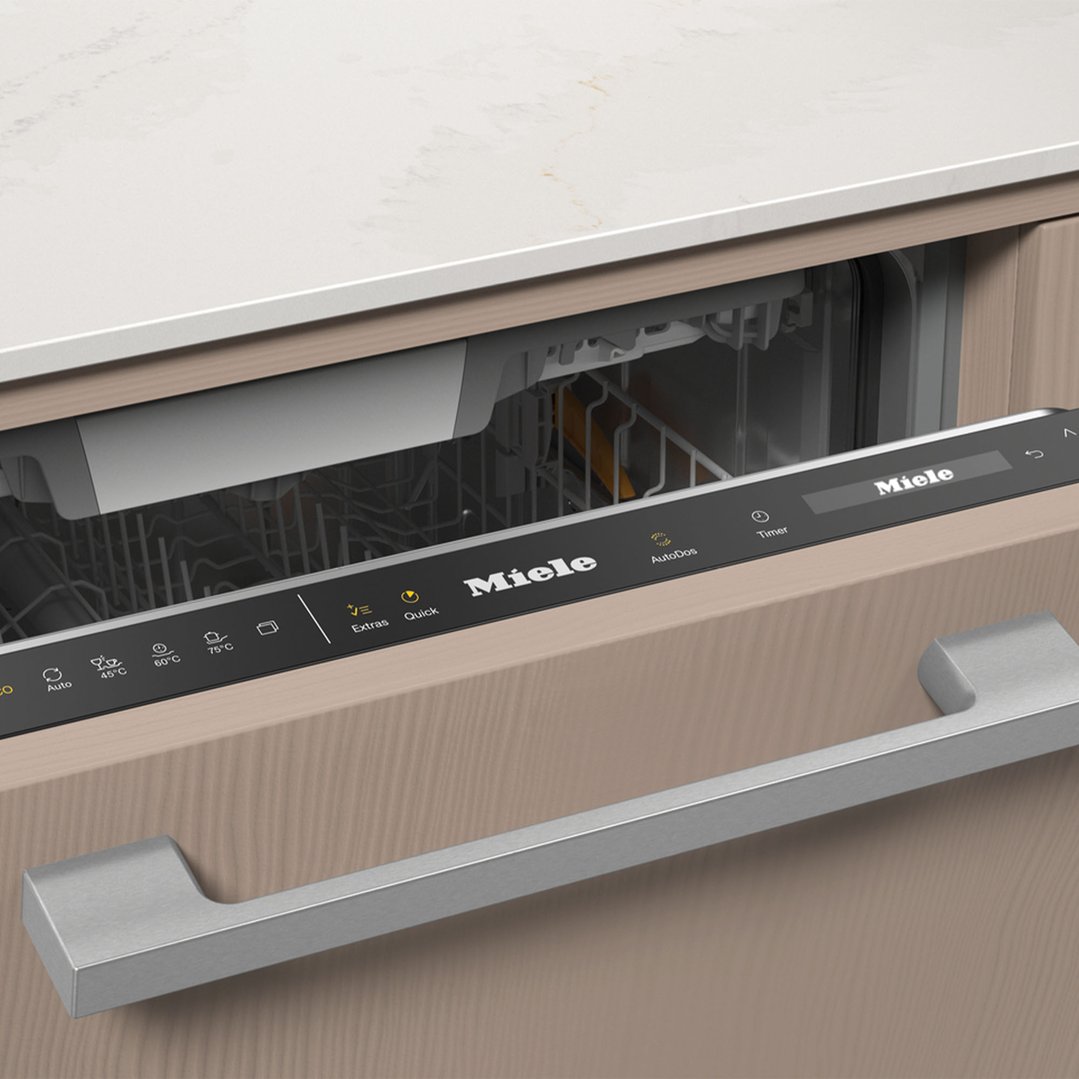 Miele dishwasher with control panel and handle in a kitchen setting