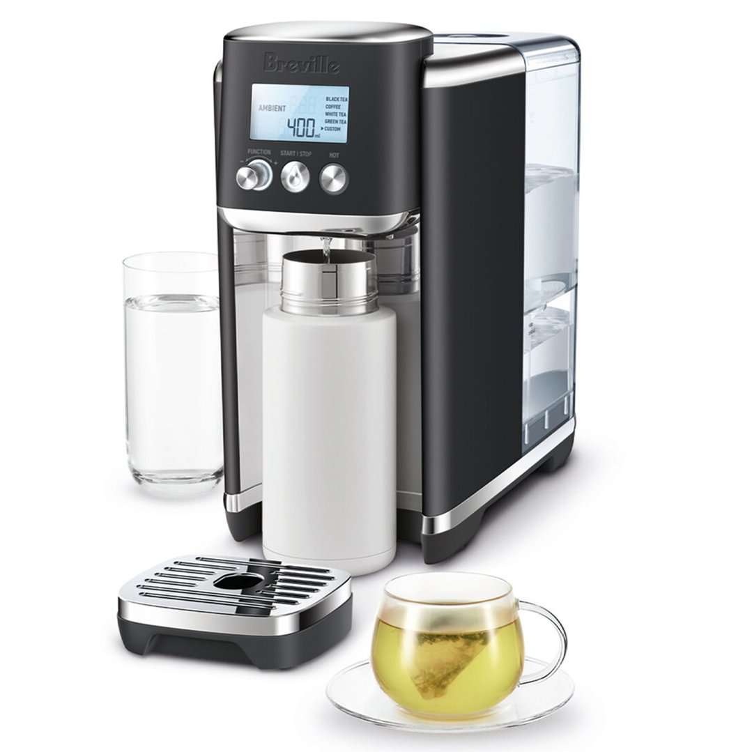 Breville AquaStation hot water dispenser with a glass of water and a cup of tea