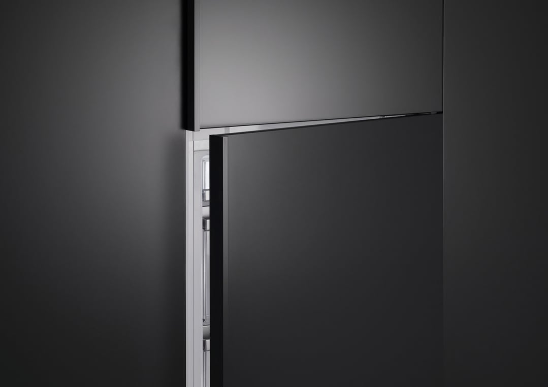 Integrated Refrigerator Freezer with the top door closed and bottom door slightly ajar