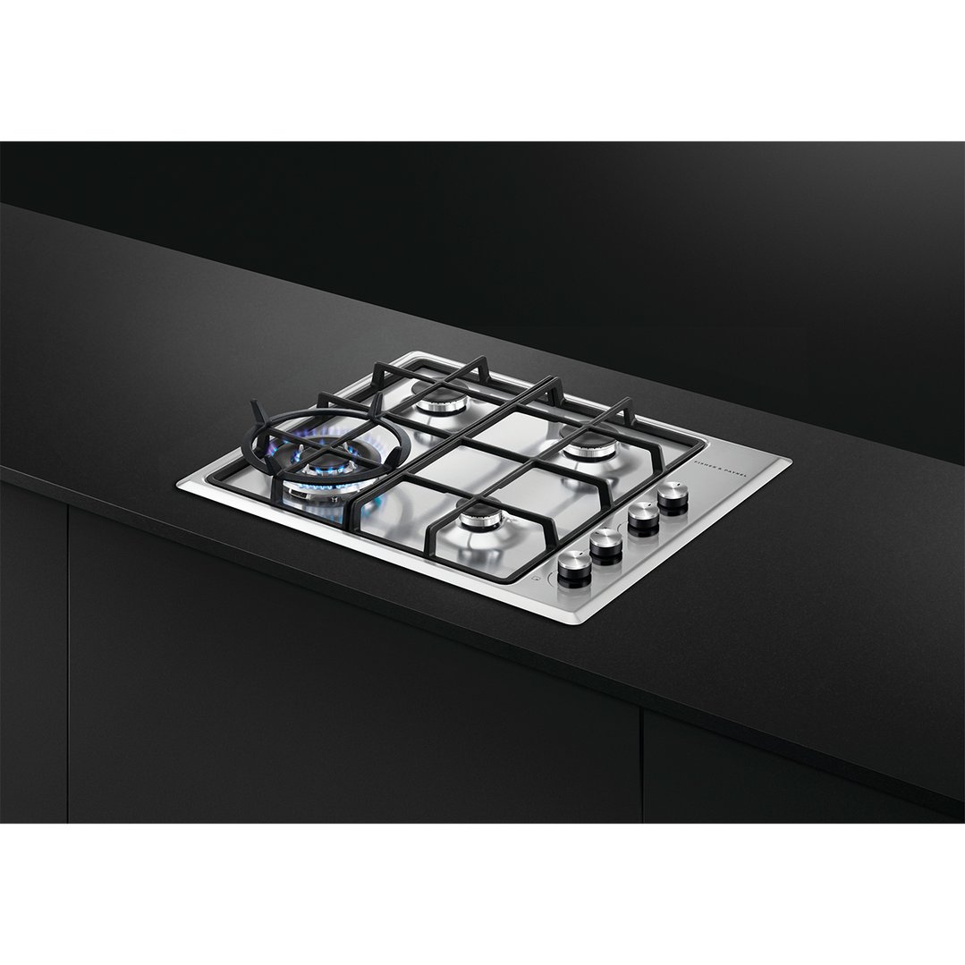 A Fisher & Paykel 4 burner gas cooktop installed in a black kitchen countertop