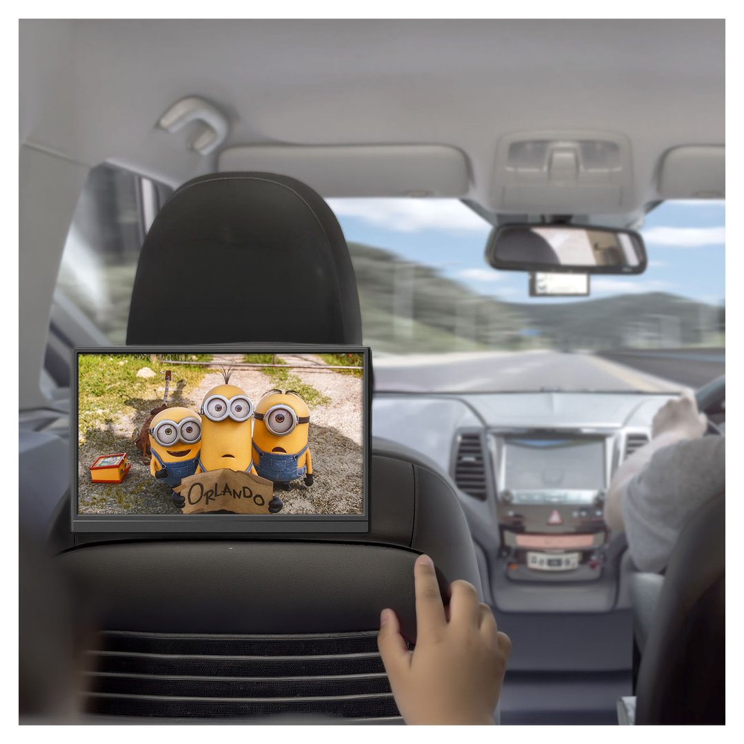 Portable monitor showing Minions in a car, child's hand reaching