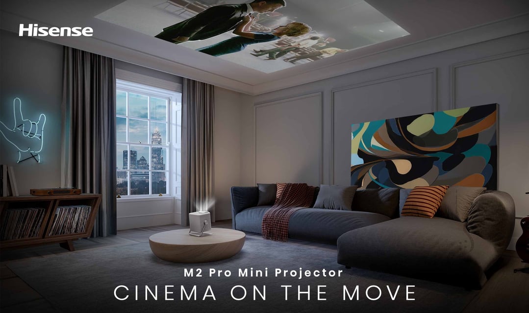 Hisense M2 Pro Mini Projector projecting a movie onto the ceiling in a living room