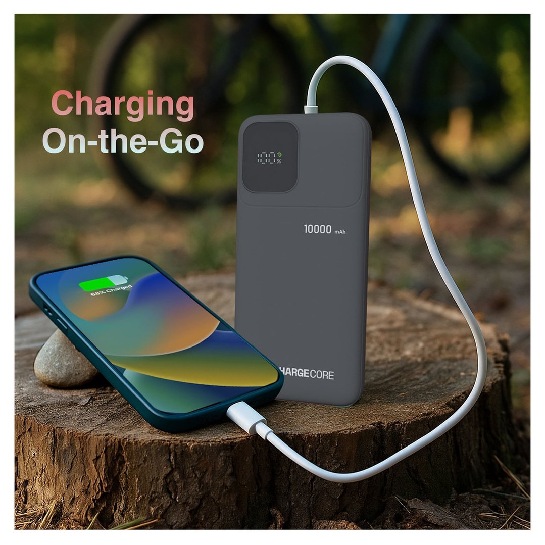 Power bank charging a smartphone on a tree stump outdoors, with text overlay