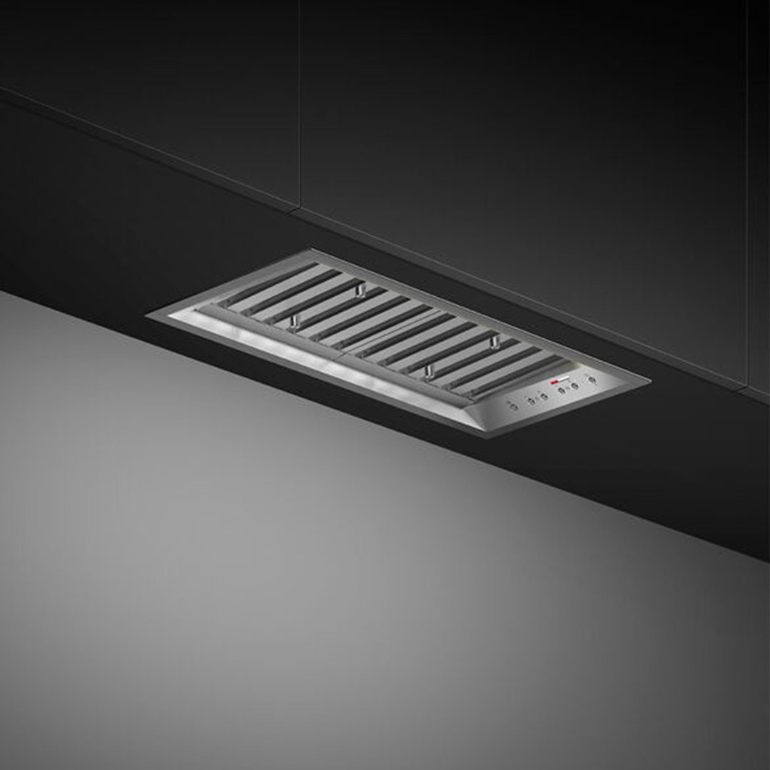 Integrated insert rangehood installed in a dark kitchen cabinet, viewed from below