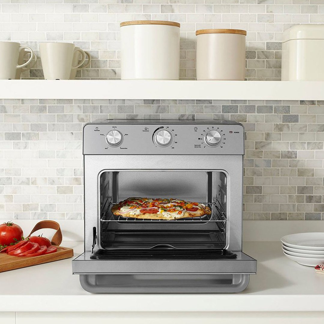 Multi Function Oven + Air Fryer with a pizza inside on a kitchen counter