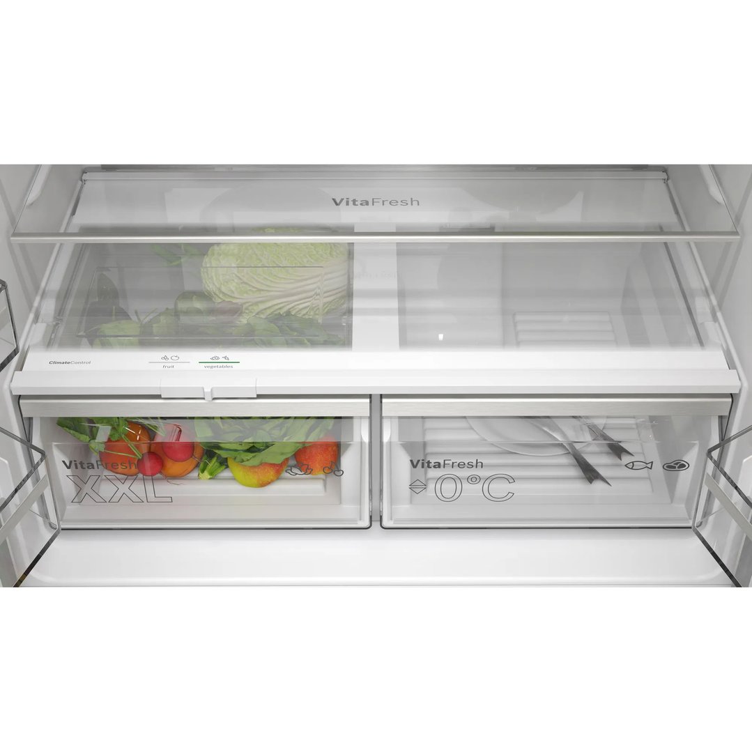 Interior view of a Bosch fridge showing VitaFresh drawers with fruits and vegetables