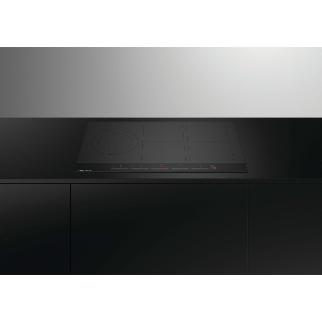 Black induction cooktop with red digital display in a modern kitchen setting