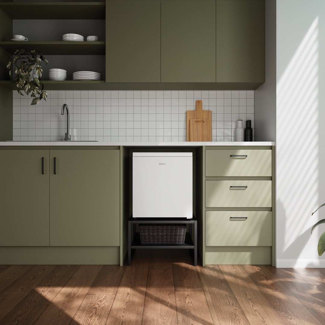 Haier bar refrigerator in a green kitchen with wooden floor