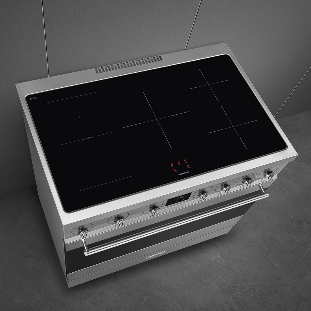 Overhead view of a stainless steel freestanding cooker with an induction cooktop