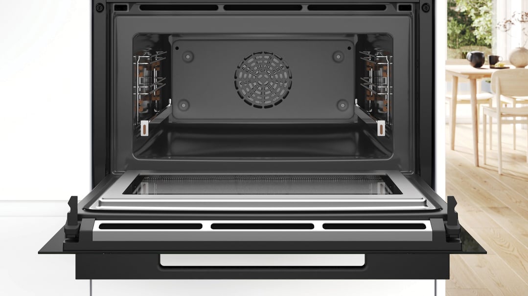 Open combination oven with microwave in a modern kitchen setting