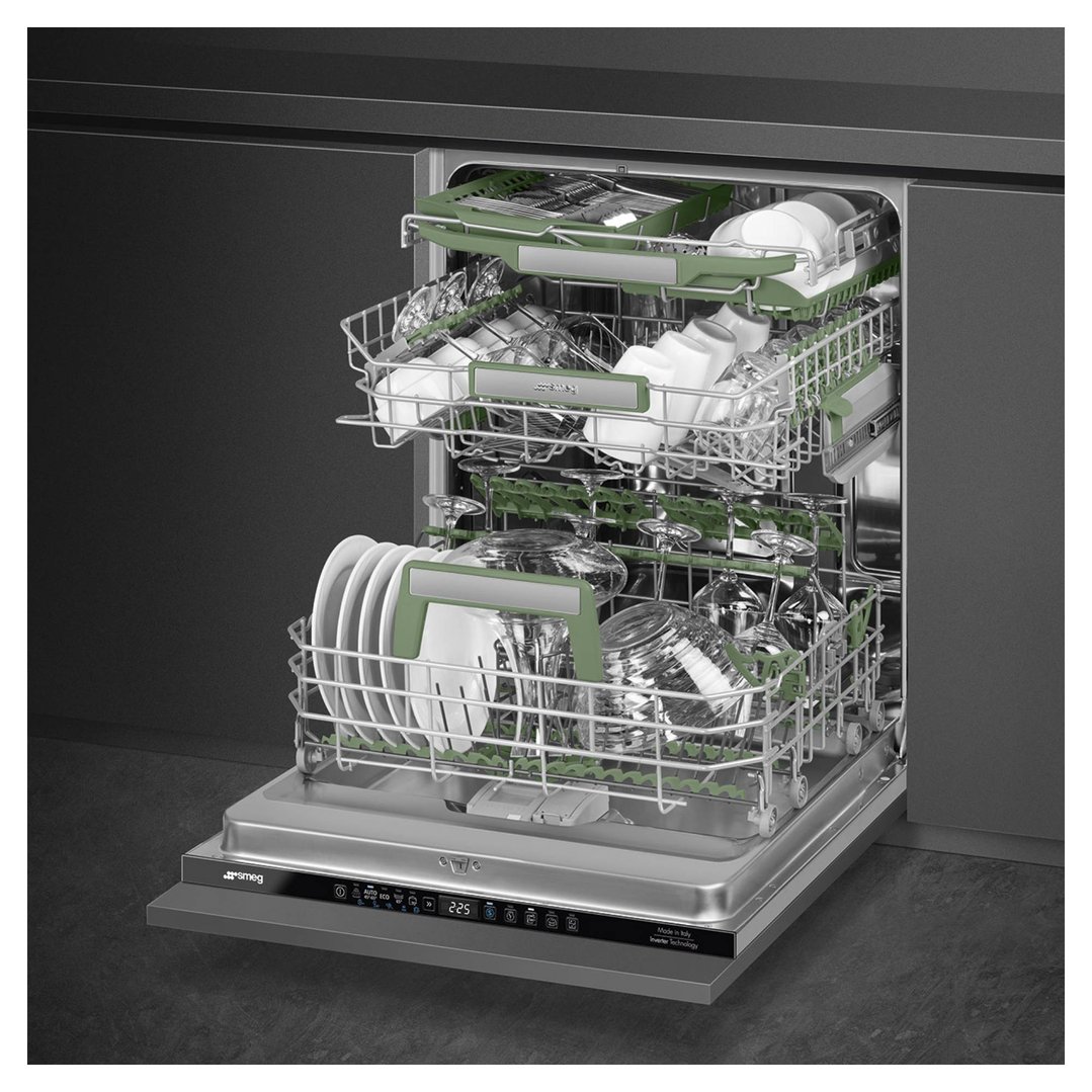 Open built-in dishwasher with green racks filled with dishes and glasses