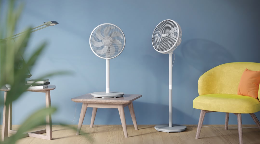 Two Philips Pedestal Fans in a room with a yellow chair and blue wall