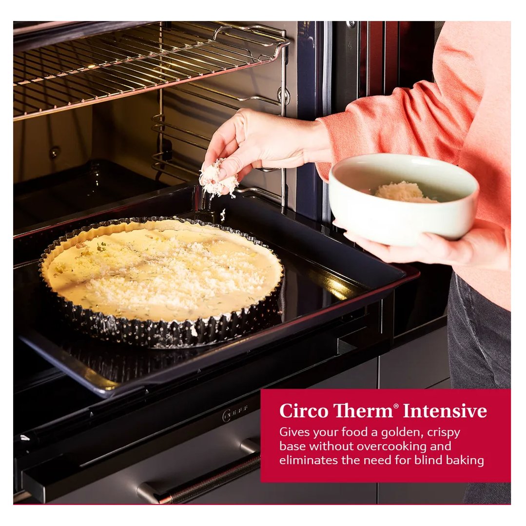 Woman's hands adding topping to a tart in a built-in oven