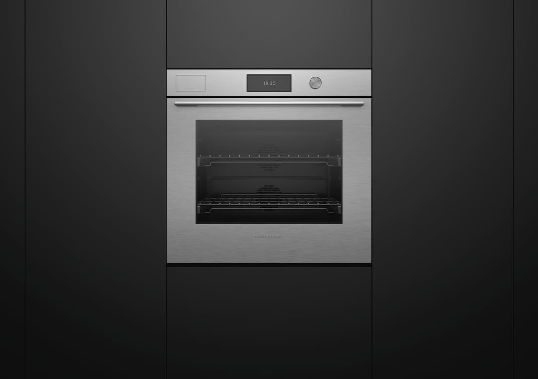 Built-in brushed silver oven with a digital display in a dark kitchen