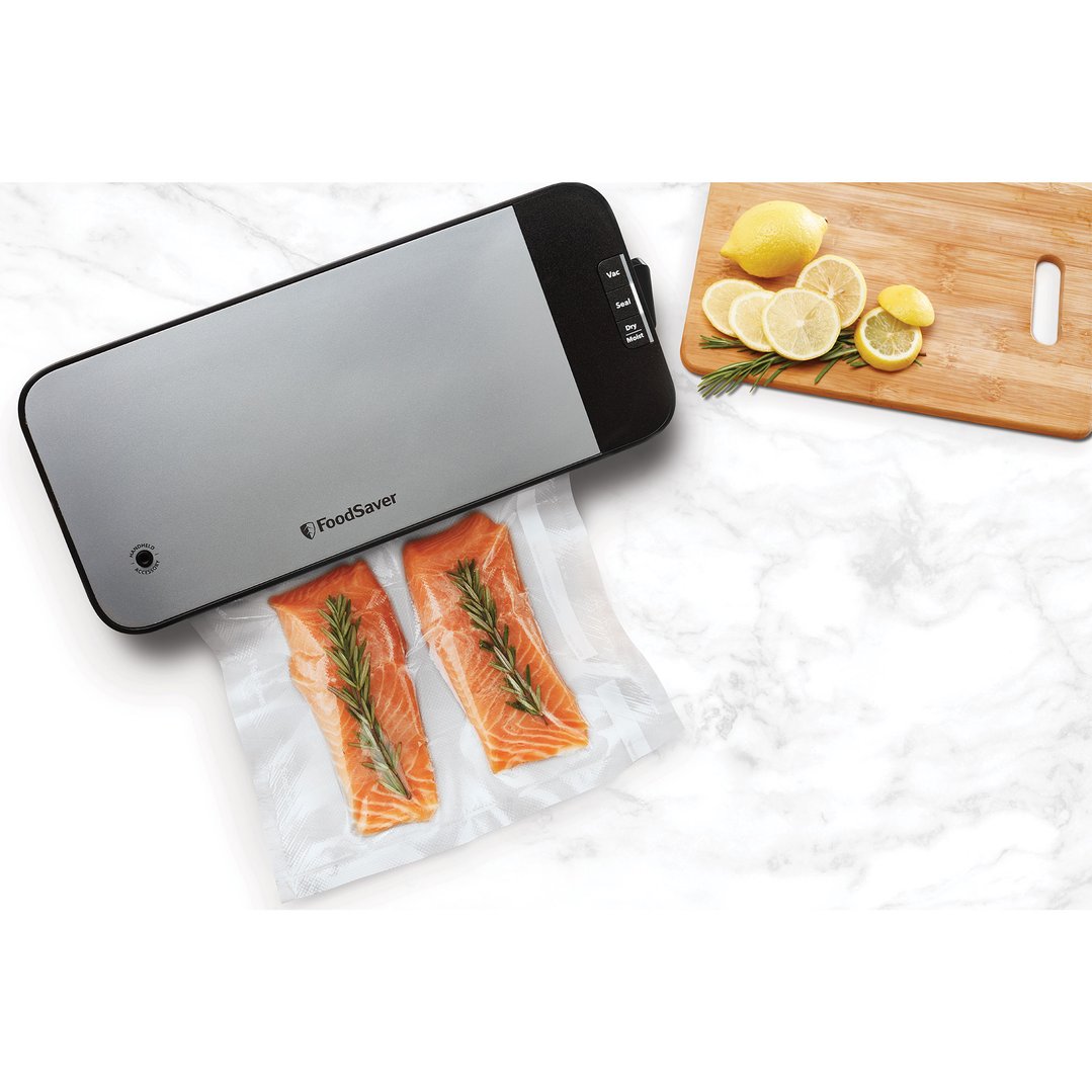 FoodSaver vacuum sealer on a marble surface with salmon and lemons