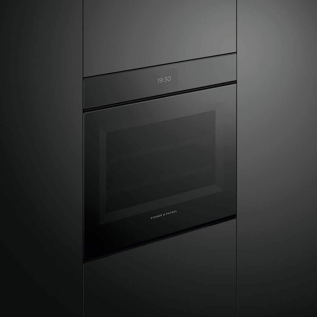 Built-in black combi-steam oven with digital display showing 19:30 in a dark kitchen