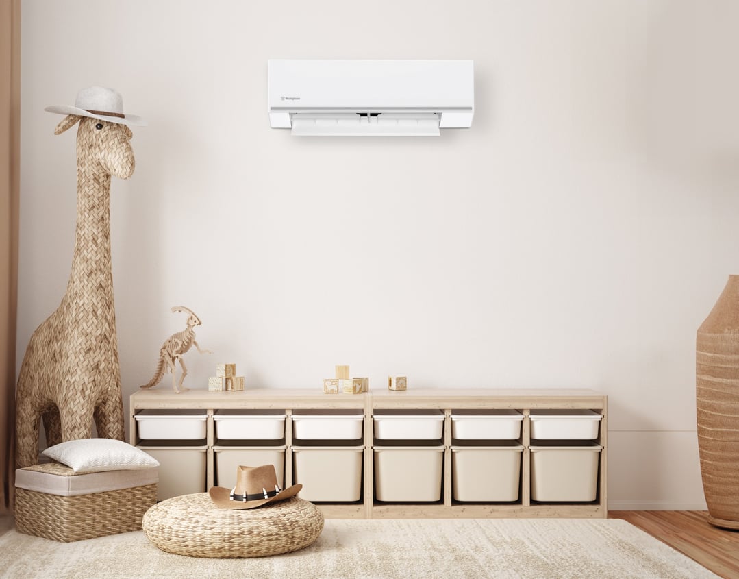 White Westinghouse split system air conditioner mounted on a wall in a child's room