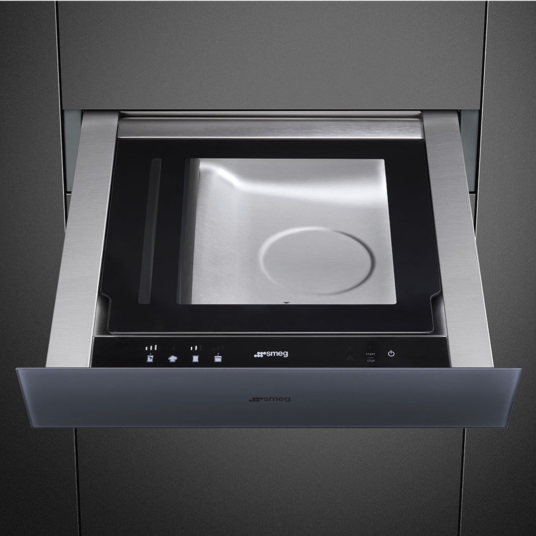 Open vacuum drawer with a stainless steel interior and control panel visible.