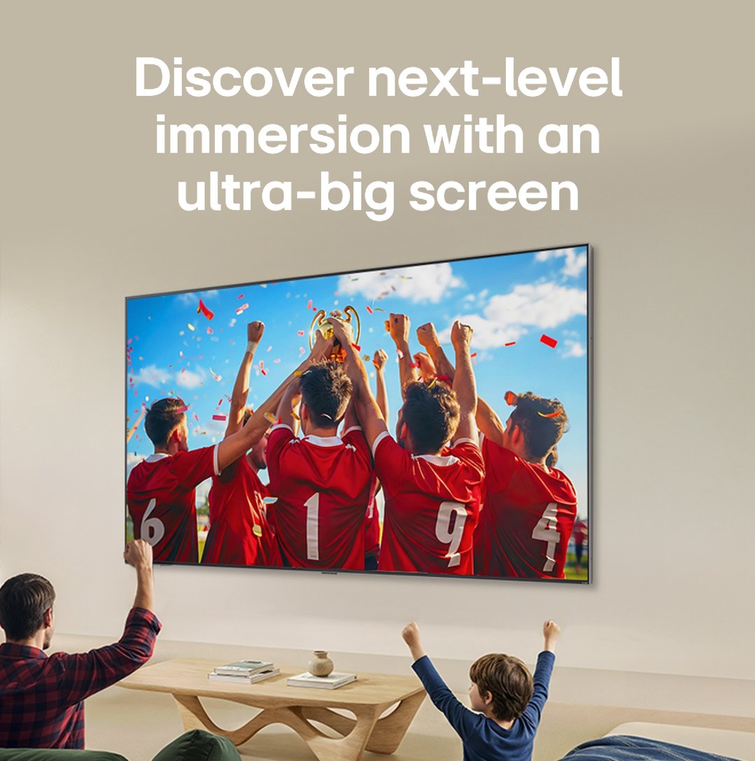 Man and child watching a football match on a large LG TV