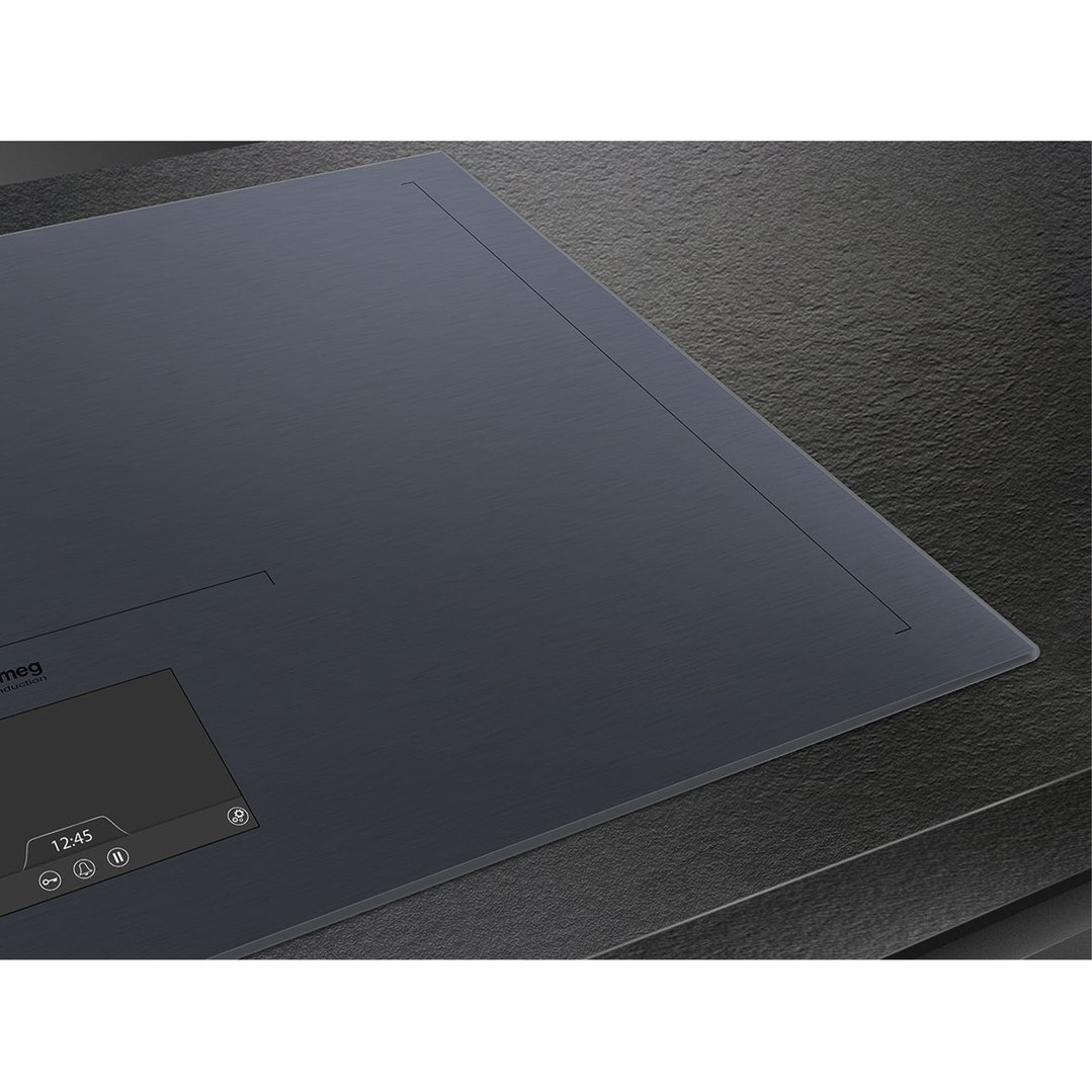 Close up of a dark grey induction cooktop with a digital display