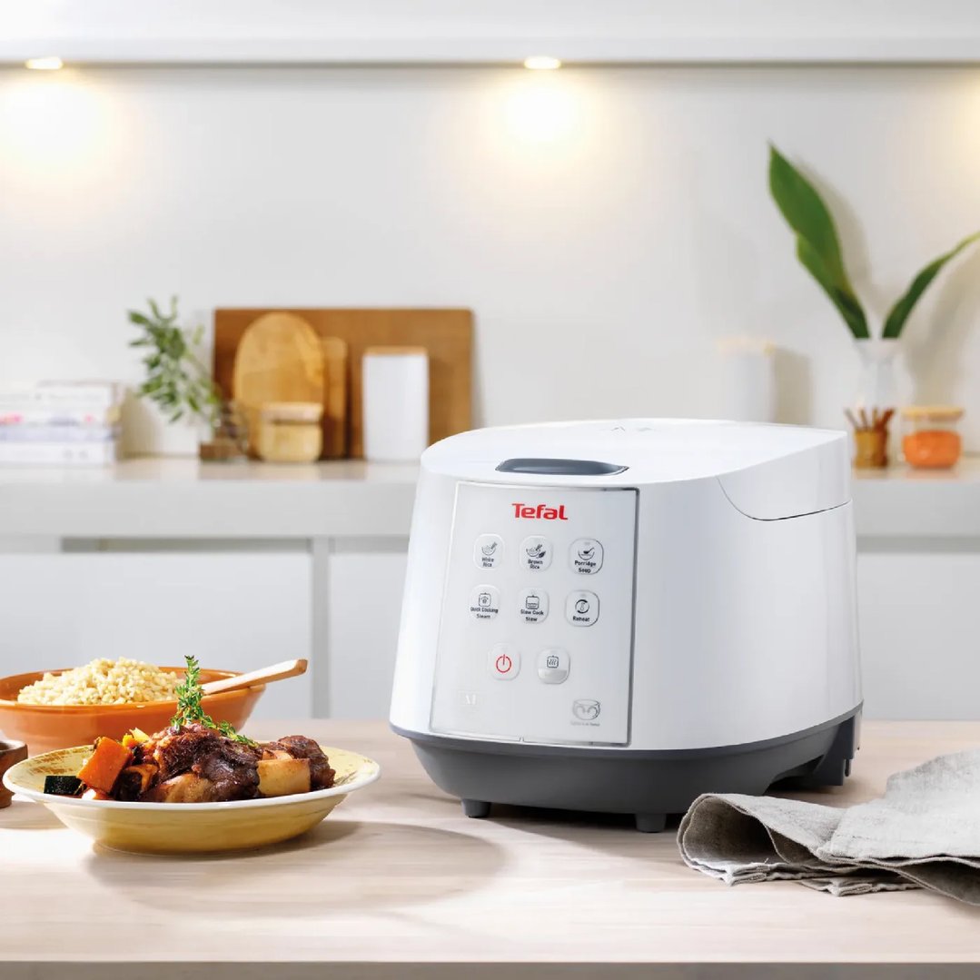 Tefal rice cooker on a kitchen counter with food bowls and kitchen decor