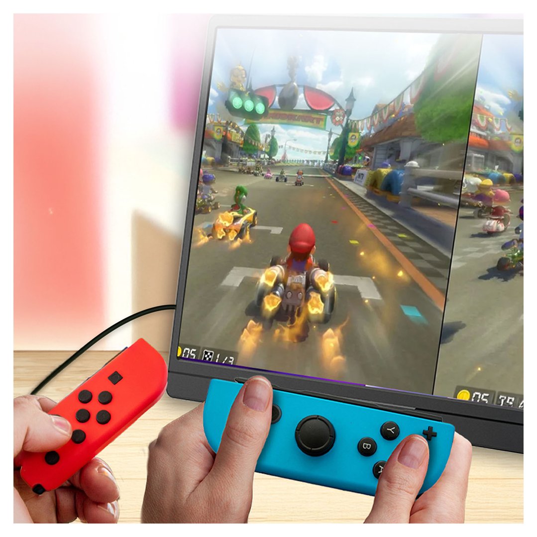 Hands holding red and blue controllers, playing Mario Kart on a monitor