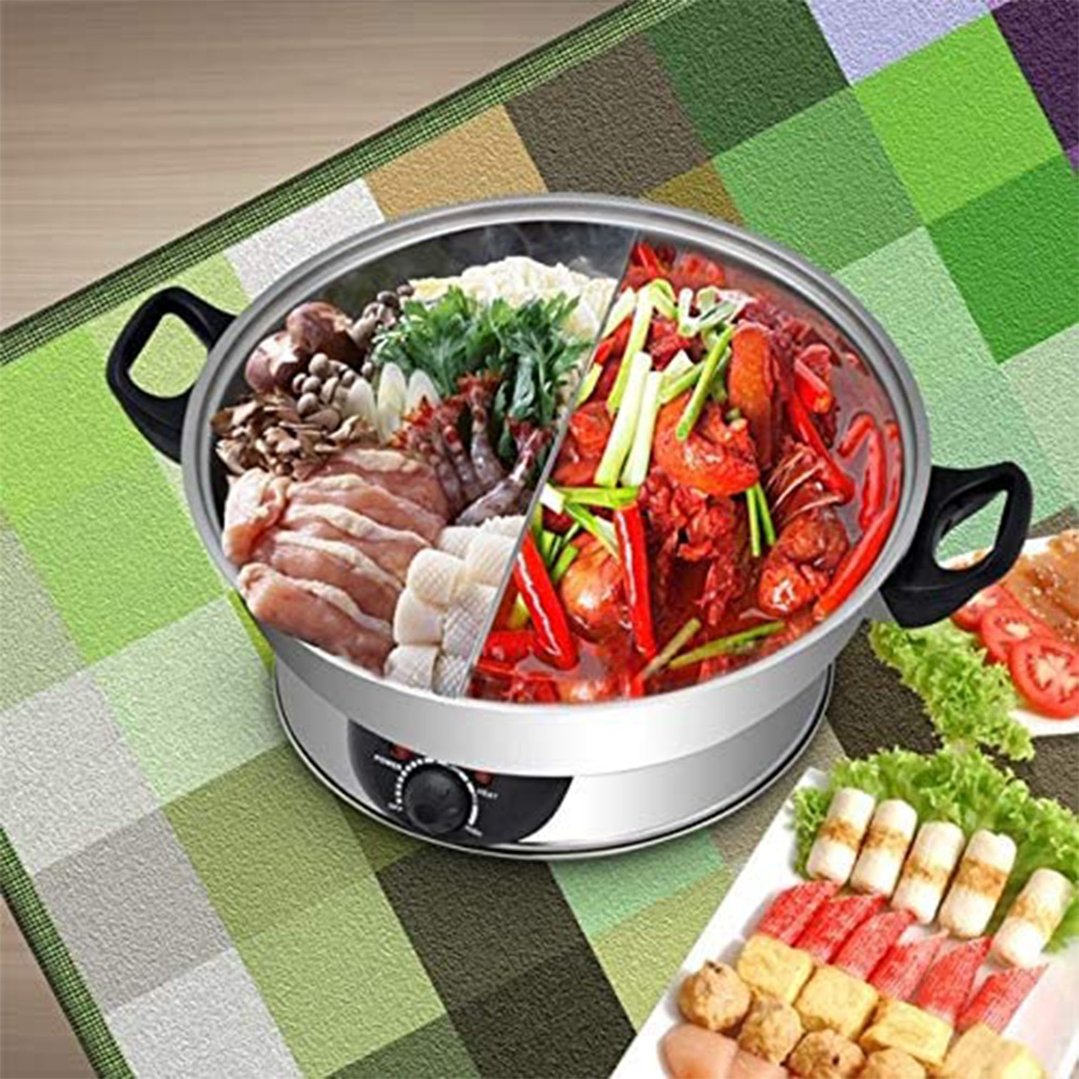 Electric hotpot filled with various ingredients on a checkered green mat