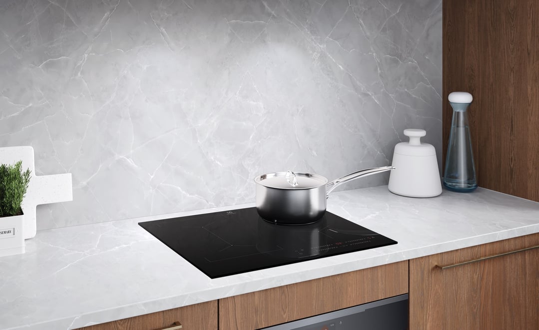 Electrolux induction cooktop with a pot on it in a modern kitchen setting