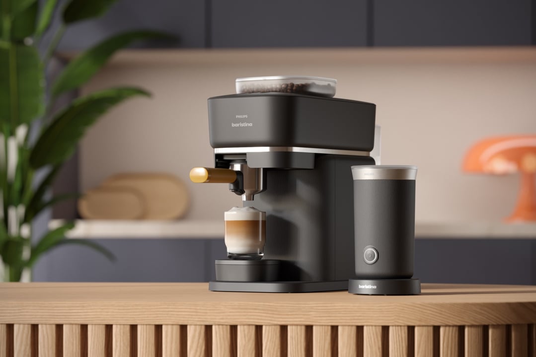 Philips Baristina Espresso Machine and milk frother on a wooden kitchen counter