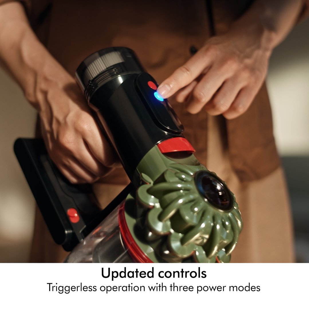 Person's hand pressing a button on a Dyson V8 Cyclone Cordless Vacuum