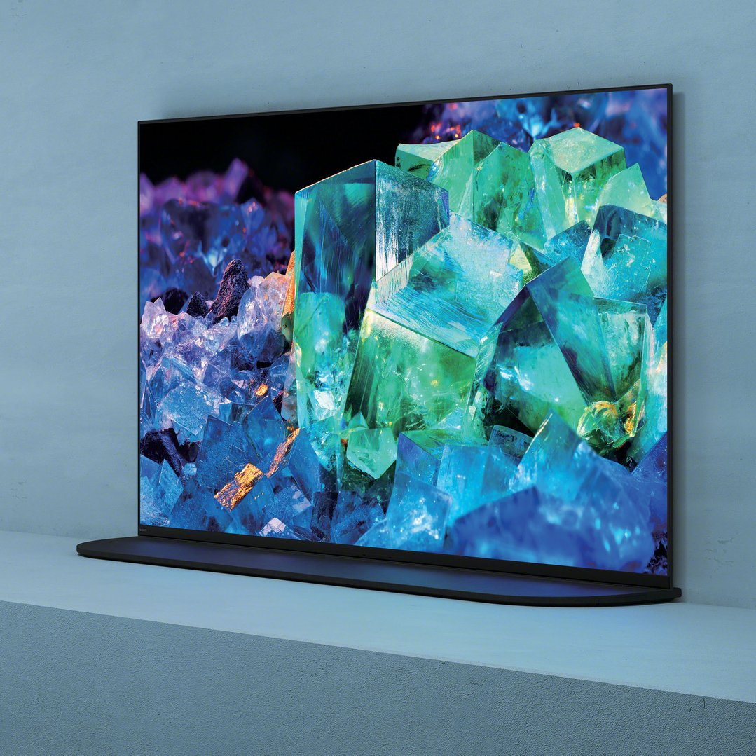 Sony 65 inch OLED TV displaying colorful crystals, on a stand