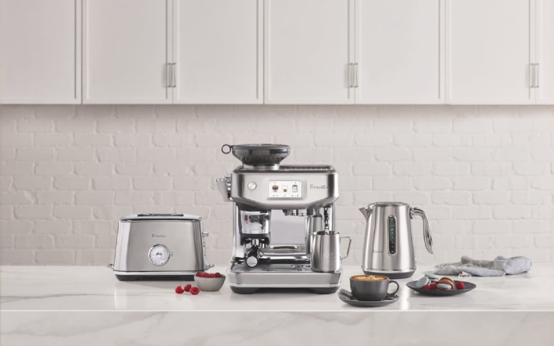 Breville Barista Touch Impress coffee machine with other appliances on a kitchen counter