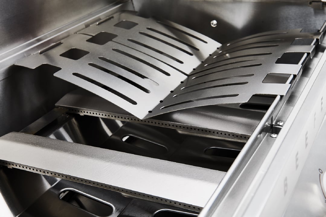 Close-up of the internal components of a stainless steel built-in barbecue