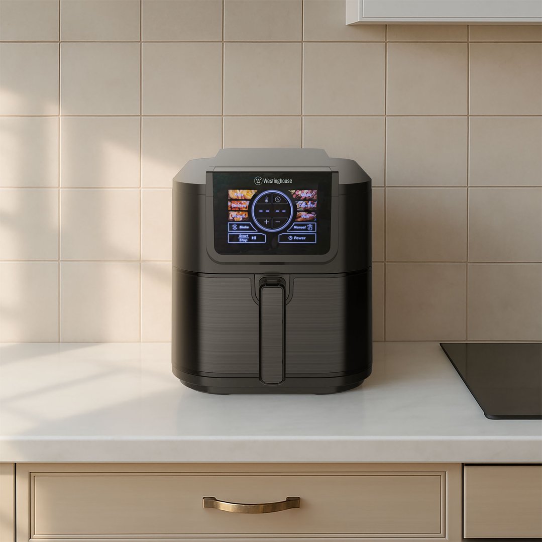 Black stainless steel air fryer on a white countertop in a kitchen setting
