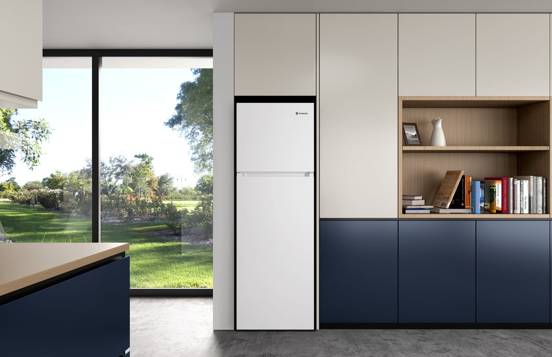 White top mount fridge in a modern kitchen with a large window overlooking a garden