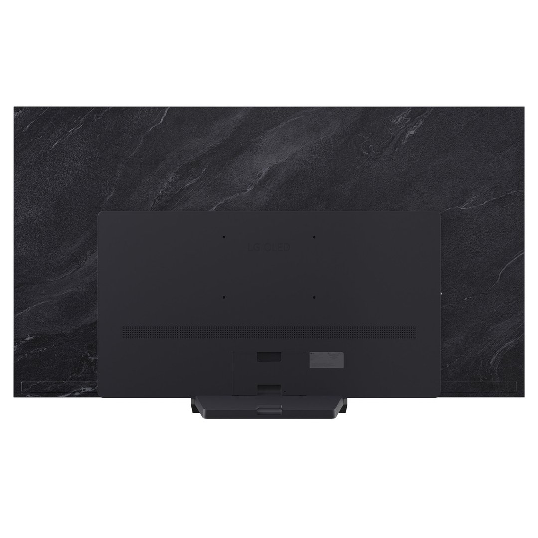 Rear view of a black LG TV on a stand against a dark marbled wall