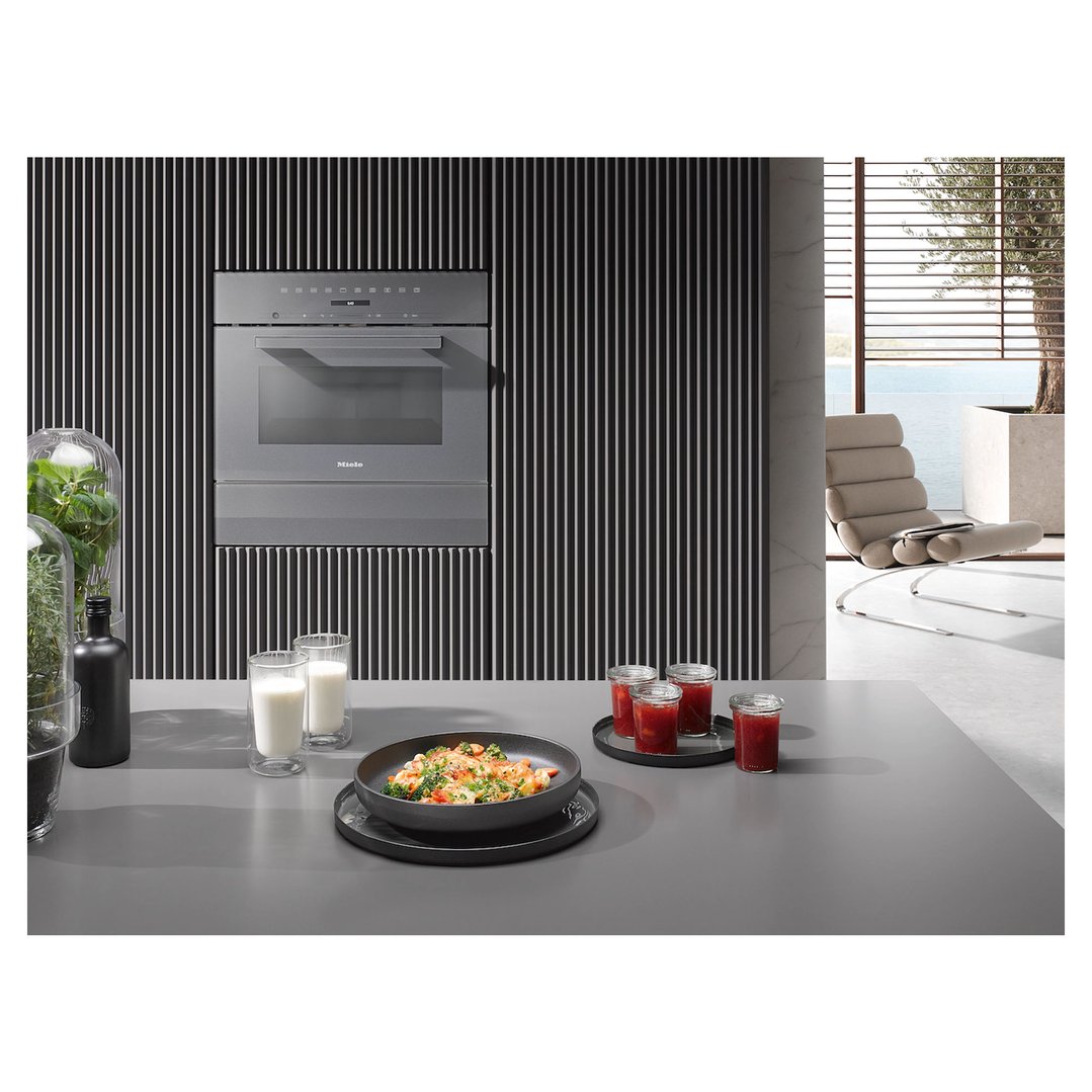 Built-in microwave with grill in a modern kitchen with food and drinks on the counter