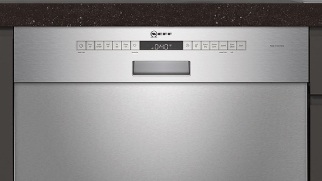 Built-under dishwasher with control panel and digital display in a kitchen setting