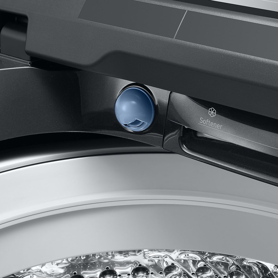 Close up of the softener dispenser and drum of a black top load washer