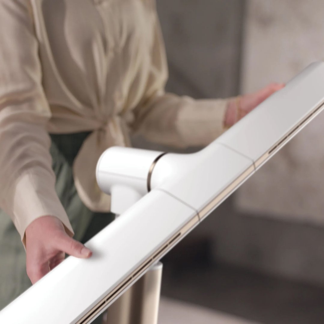 Person holding a white TurboBlade fan with both hands