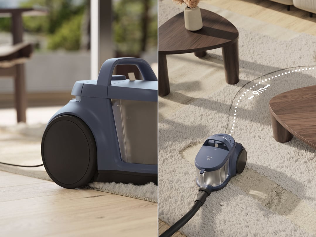 Blue bagless vacuum cleaner on a rug in a living room setting