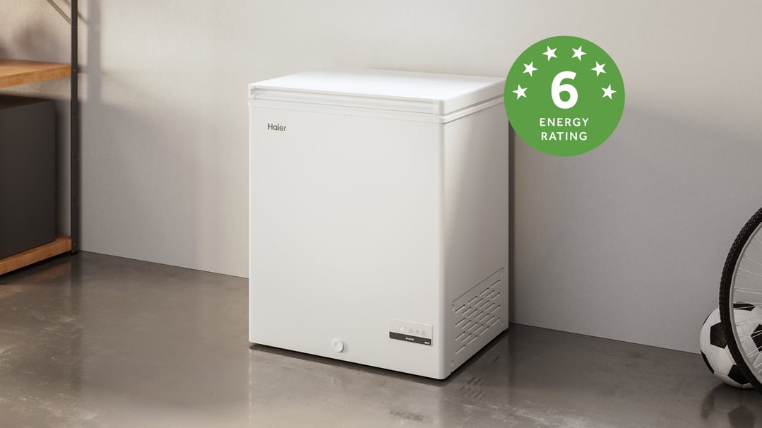 White Haier chest freezer with 6-star energy rating in a garage setting