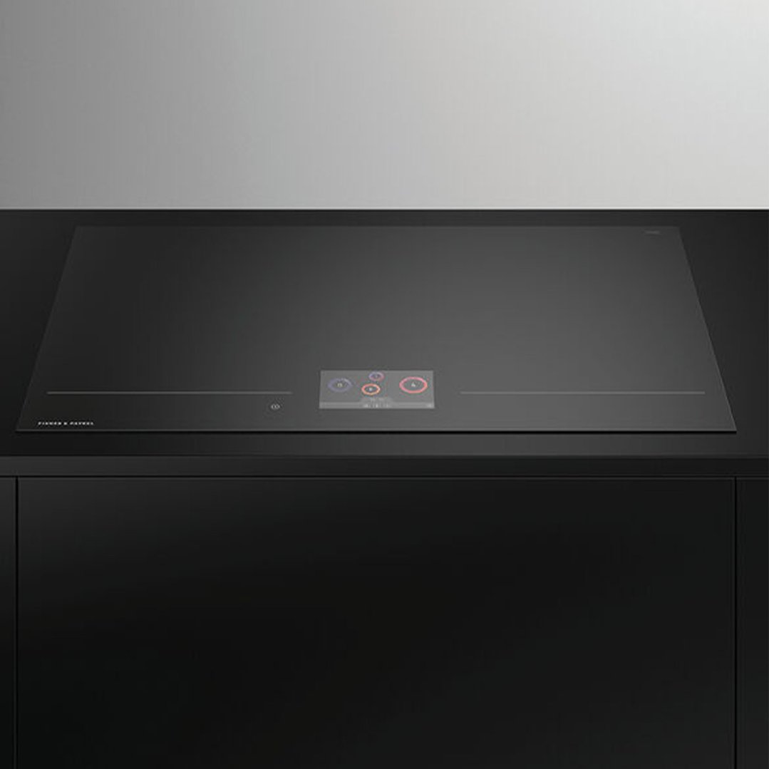 Black induction cooktop with a digital display in a modern kitchen setting