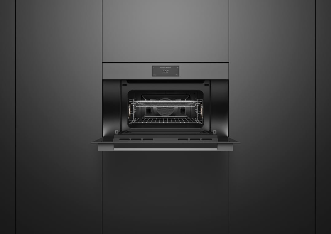 A built-in compact combi-steam oven with its door open, showing the interior