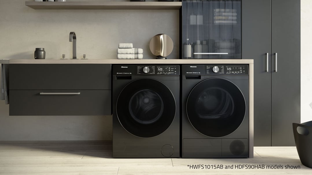 Two Hisense washing machines in a modern laundry room with a sink