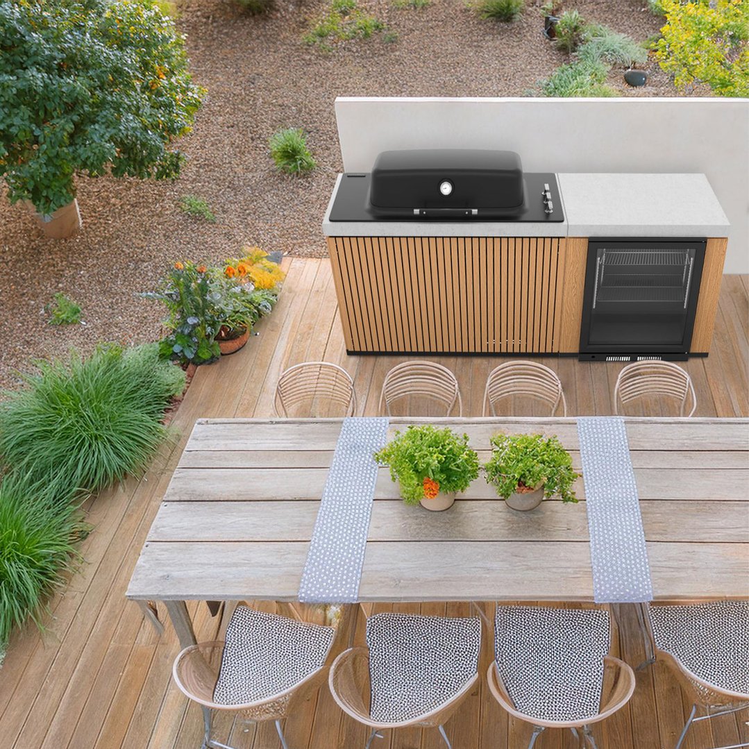 Overhead view of a black built-in barbecue in an outdoor kitchen setting