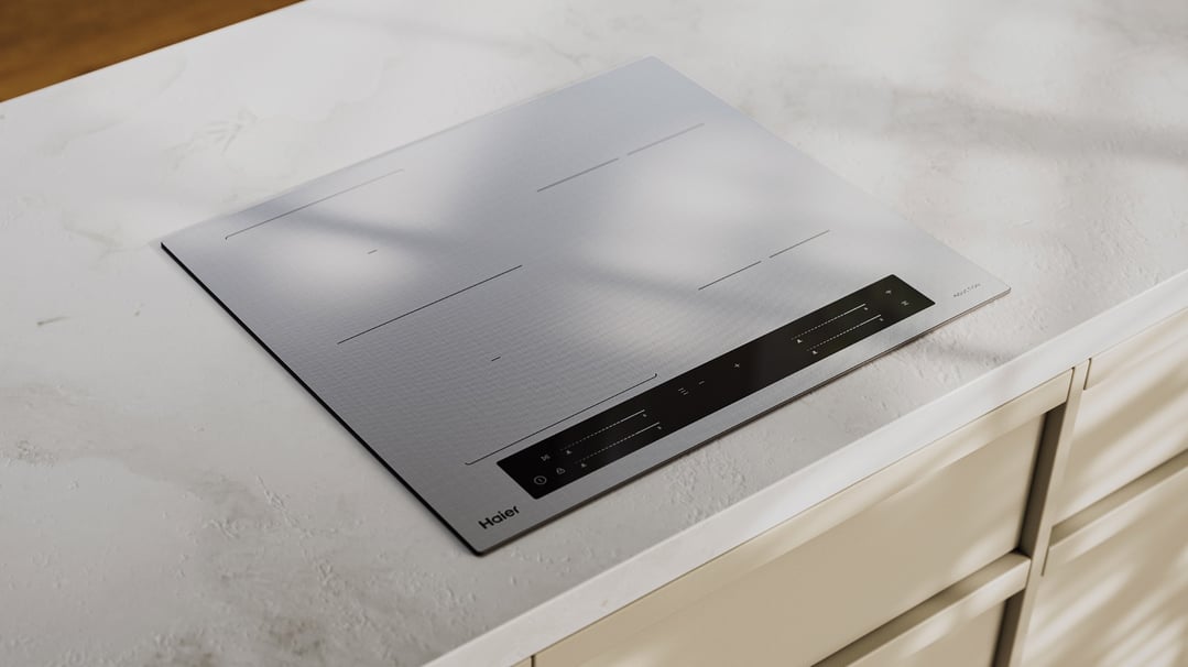 A grey Haier induction cooktop built into a white countertop in a kitchen