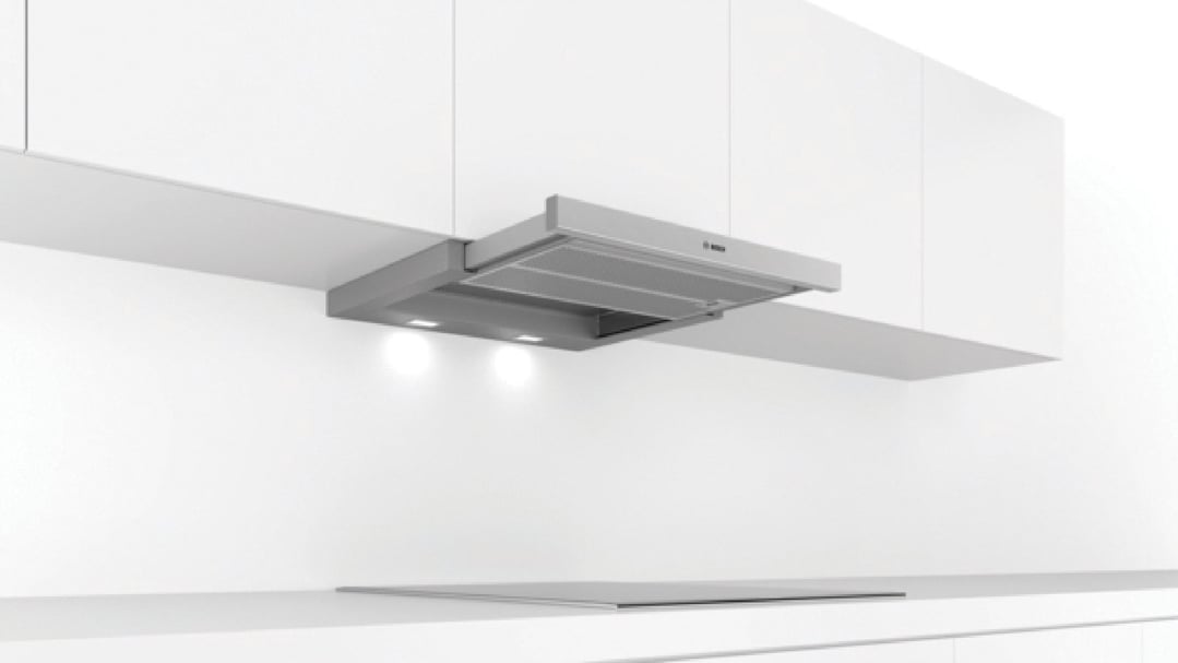 Bosch slideout rangehood installed above an induction cooktop in a white kitchen