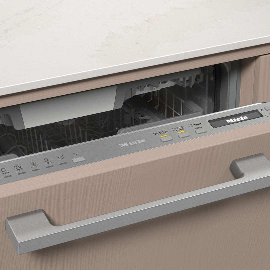 Close up of a Miele dishwasher with its door slightly ajar